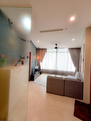 a living room with a couch and a large window at Vortex klcc by hr in Kuala Lumpur
