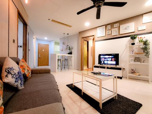 a living room with a couch and a tv at Vortex klcc by hr in Kuala Lumpur