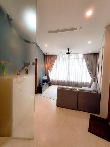 a living room with a couch in front of a window at Vortex klcc by hr in Kuala Lumpur