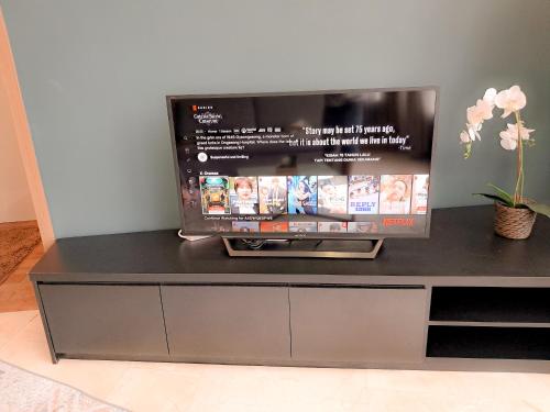 a flat screen tv sitting on top of a entertainment center at Vortex klcc by hr in Kuala Lumpur
