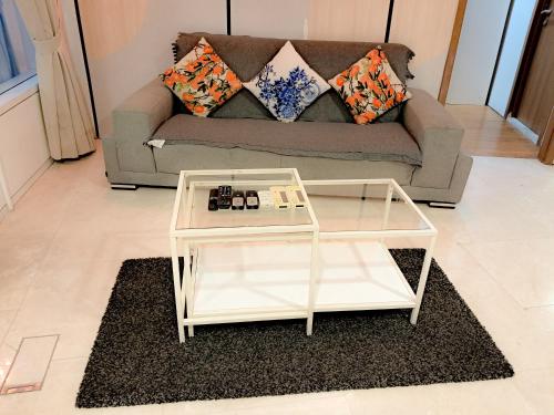 a living room with a couch and a glass coffee table at Vortex klcc by hr in Kuala Lumpur