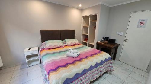 a bedroom with a bed with two stuffed animals on it at Hotel Firenze in Necochea