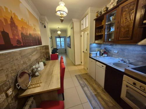 una cucina con un lavello e un tavolo di legno di Authentic Belgrade Centre Hostel - Only Private Rooms, Paid Parking on-site, Mandatory Reservation a Belgrado