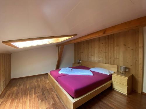 a bedroom with a bed with purple sheets and a light at Haus Angelika in Vandans
