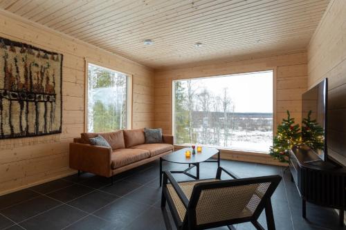 a living room with a couch and a table at Kajo Sky Lodge in Rovaniemi