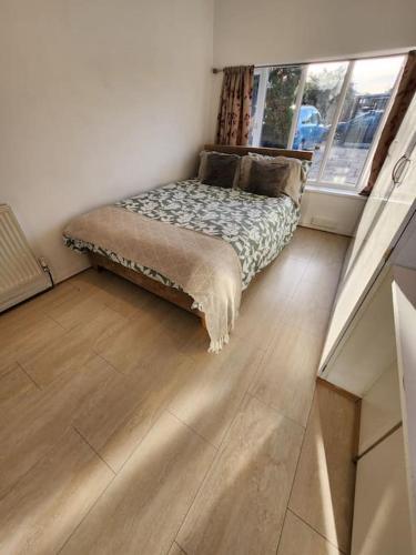a bedroom with a bed in a room with a window at Idyllic Cottage in Garforth