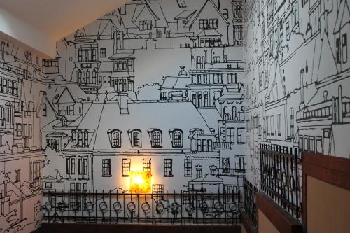 a wall mural of a city with buildings at Troyanda in Radyvyliv