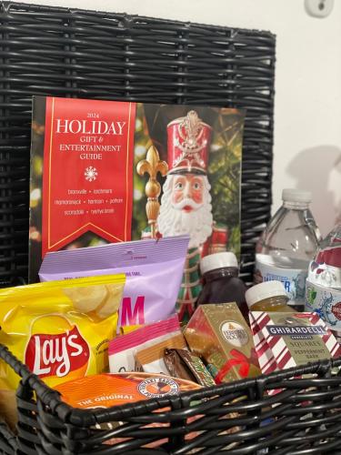 a basket filled with christmas food and a santa clause at Pelham Haven Suite in New York in Pelham