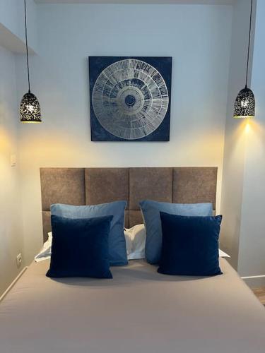une chambre avec un lit avec des oreillers bleus dans l'établissement Riviera Sky, appartement design centre Croisette, à Cannes