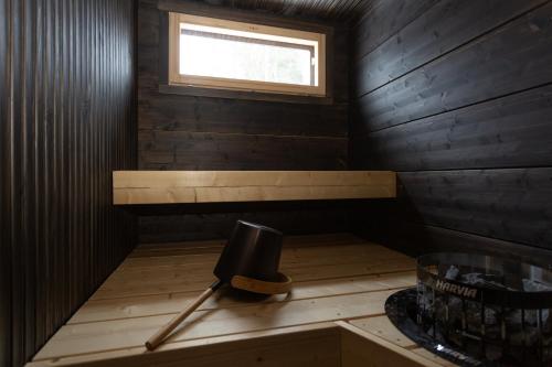 a small room with a sauna with a window at Kajo Sky Lodge in Rovaniemi