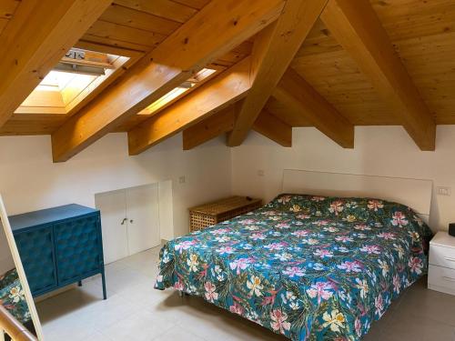 a bedroom with a bed and wooden ceilings at La Casetta in LʼAquila