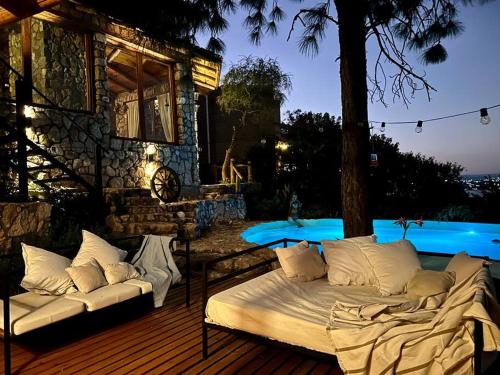 a bed sitting on a deck next to a house at Casa de ensueño in Villa Carlos Paz