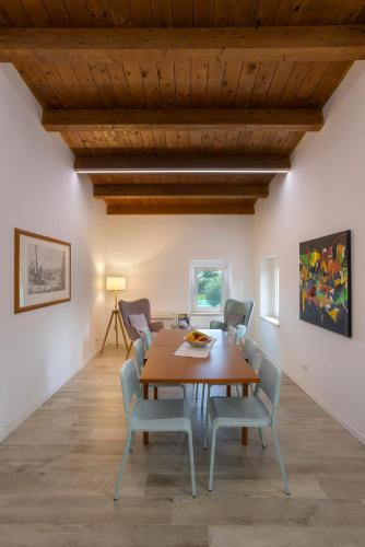 a dining room with a wooden table and chairs at Casal La Ponderosa in SantʼElpidio a Mare