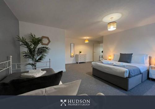 a bedroom with a bed and a plant in it at Open Plan Townhouse in Shrewsbury in Shrewsbury
