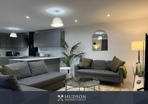 a living room with two couches and a kitchen at Open Plan Townhouse in Shrewsbury in Shrewsbury
