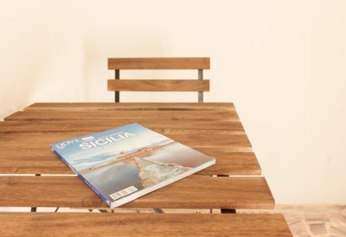 a magazine sitting on top of a wooden table at Artemisia in Vittoria