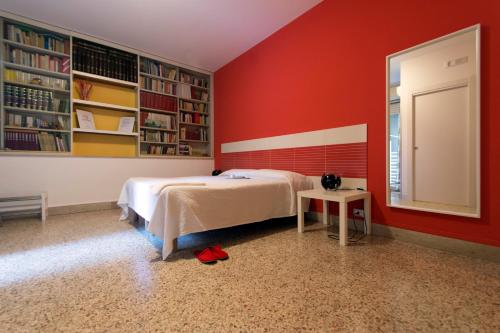 a bedroom with a bed and a mirror and bookshelves at Artemisia in Vittoria