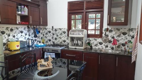 a kitchen with a sink and a stove top oven at Jithu homestay Mirissa in Mirissa
