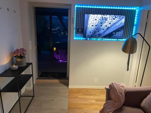 a living room with a mirror with blue lights at Bingo apartaments in Hønefoss