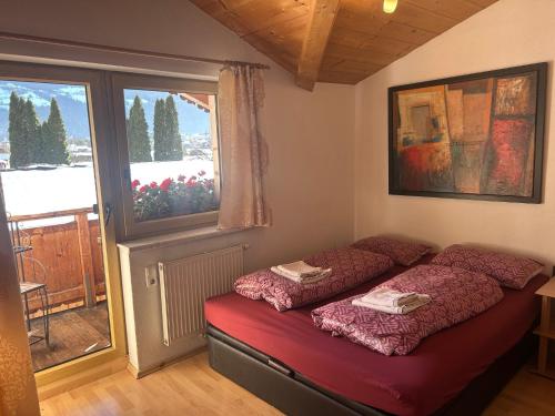 a room with two beds in it with a window at Gasthof Rafting Alm in Haiming