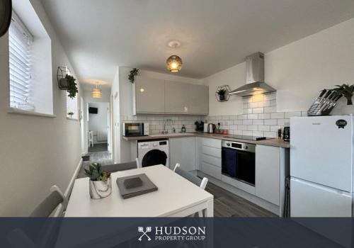 a kitchen with a table with a laptop on it at Detached House in Telford with Parking in Telford