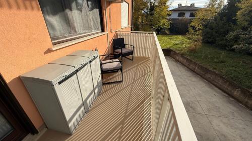 an outdoor deck with an air conditioner on a house at Rose e Frutta - Sweet Dreams in Begliano