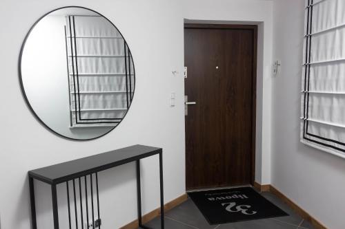 a mirror on a wall next to a door at Lipowa32 Apartamenty in Hrubieszów