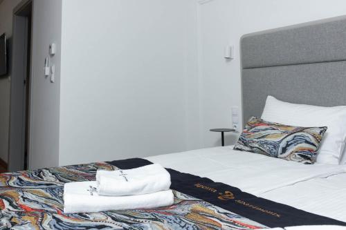 a bedroom with a bed with towels on it at Lipowa32 Apartamenty in Hrubieszów