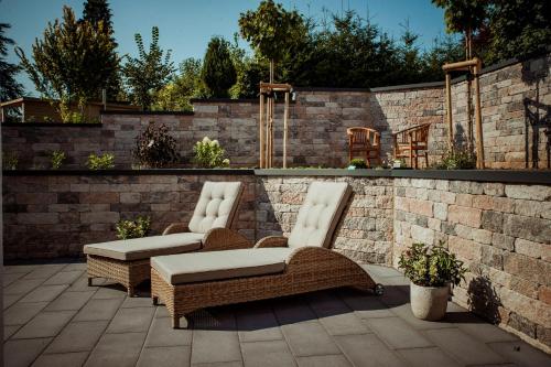 two wicker chairs sitting on a patio at Ferienhaus Eifeltoni in Nettersheim