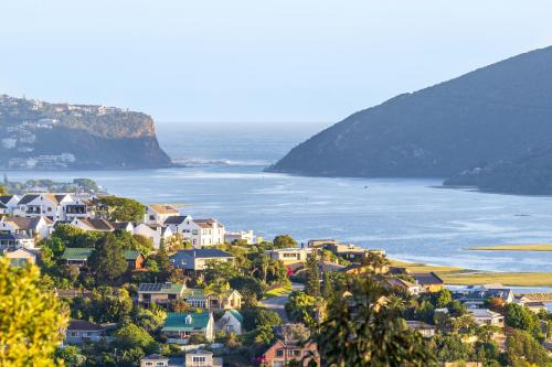 a town on a hill next to the water at Cozy Retreat in Knysna