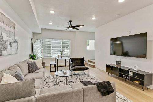 a living room with a couch and a flat screen tv at 3 Mins to DT Lux Townhome 2 Car Garage King Bed in Salt Lake City