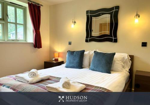 a bedroom with a large bed with towels on it at Beautiful Cottage in the Heart of Shrewsbury in Shrewsbury