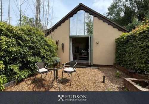 a table and two chairs in front of a house at Beautiful Cottage in the Heart of Shrewsbury in Shrewsbury