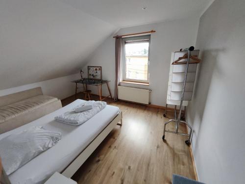 a small bedroom with a bed and a window at XL Rooftop in Siegburg