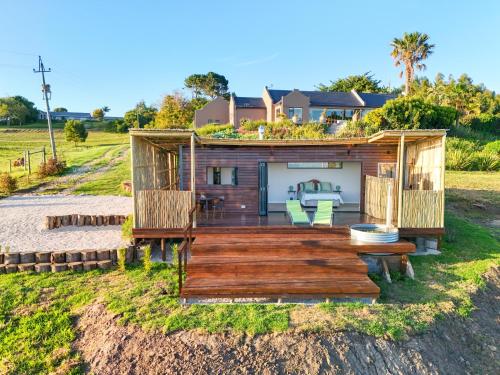 a house on the beach with a deck at Cozy Retreat in Knysna