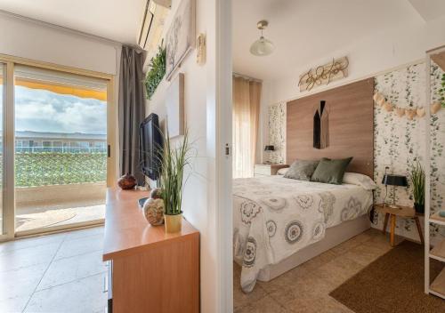 a bedroom with a bed and a view of the ocean at Salou Luxury Stay Beach Pool Parking AC in Salou