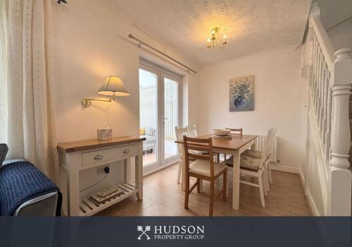 a dining room with a table and a desk and a table and chairs at 3 Bedroom House with Garden in Admaston