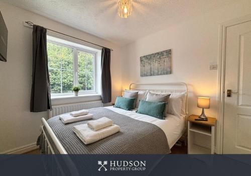 a bedroom with a bed with two towels on it at 3 Bedroom House with Garden in Admaston