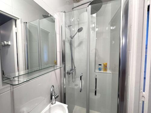 une salle de bain avec une douche en verre et un lavabo dans l'établissement One Bedroom Apt - Subway 5 min -Quiet Neighborhood, à Montrouge