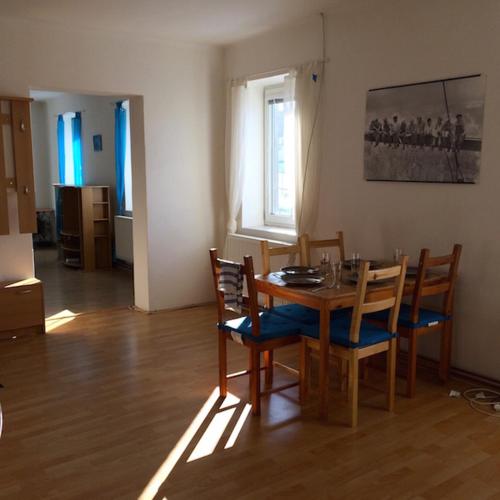 a dining room with a wooden table and chairs at Apartment Liberec Stříbrný Kopec in Liberec