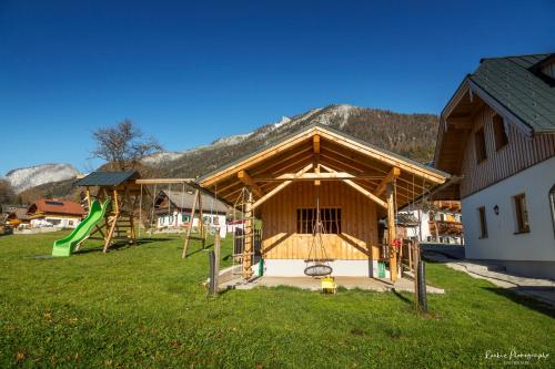 a building with a playground with a slide at Reiterhof Suassbauer in St. Wolfgang