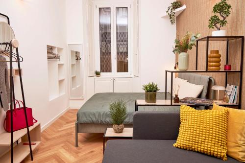 a living room with a couch and a window at MILANO URBAN FLATS Suite Sanzio 20 - Vicino a Duomo, Stadio e Fiera in Milan
