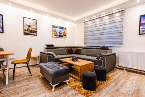 a living room with a couch and a table at SKS plus in Pale