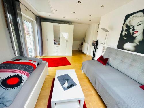 a living room with a couch and a table at Haus Dragl Apartment in Friedberg