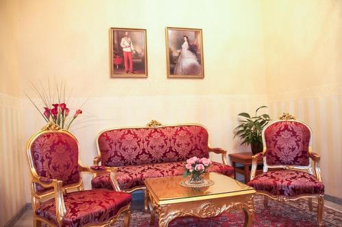 a living room with two chairs and a table at Pension Opera Suites I Self Check In in Vienna