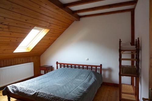 a bedroom with a bed and a wooden ceiling at Celestia in Moieciu de Sus