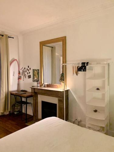 a bedroom with a bed and a sink and a mirror at Full house Canal Saint-Martin in Paris