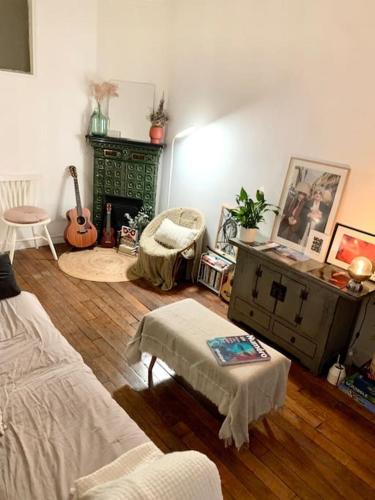 a living room with a couch and a table at Full house Canal Saint-Martin in Paris