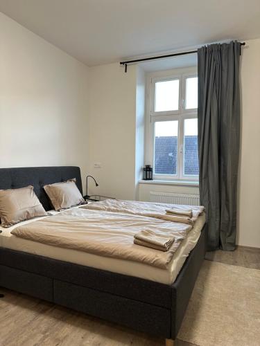 מיטה או מיטות בחדר ב-Apartmán Palackého