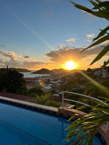 a view of the sunset from a swimming pool at The Mary Anne Boutique Hotel USVI in Charlotte Amalie